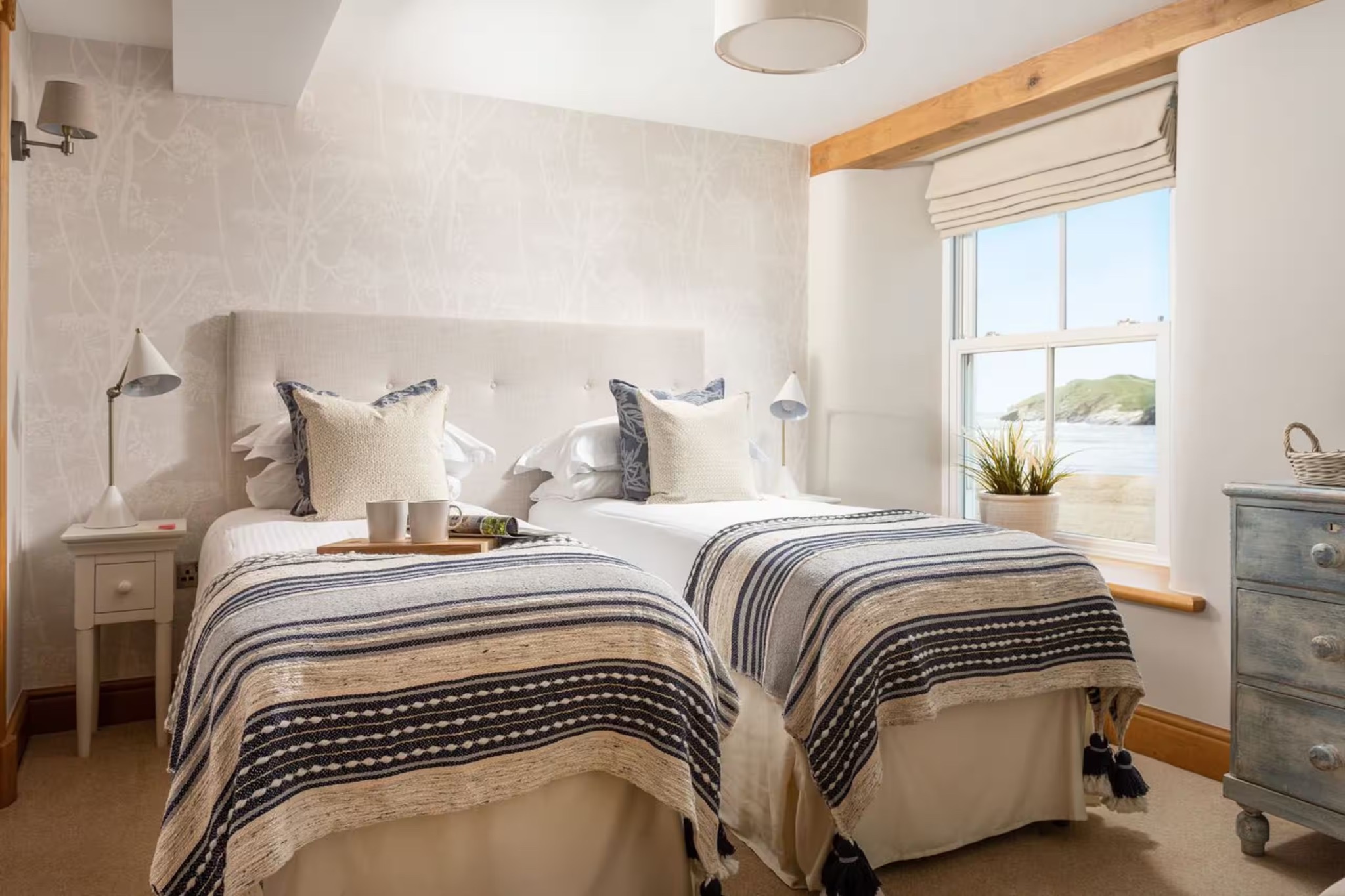 Twin bedroom with two single beds and beach view